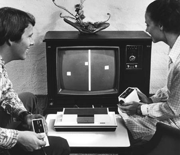 Two people playing Pong on a Magnavox Odyssey cgame console.